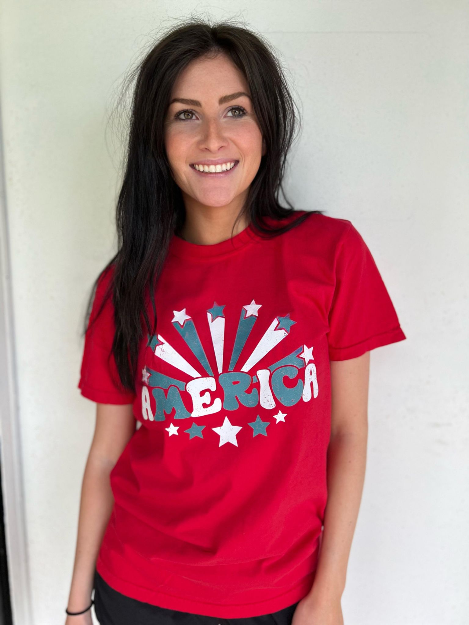 A vibrant red America Stars Tee featuring a patriotic design, perfect for 4th of July celebrations.