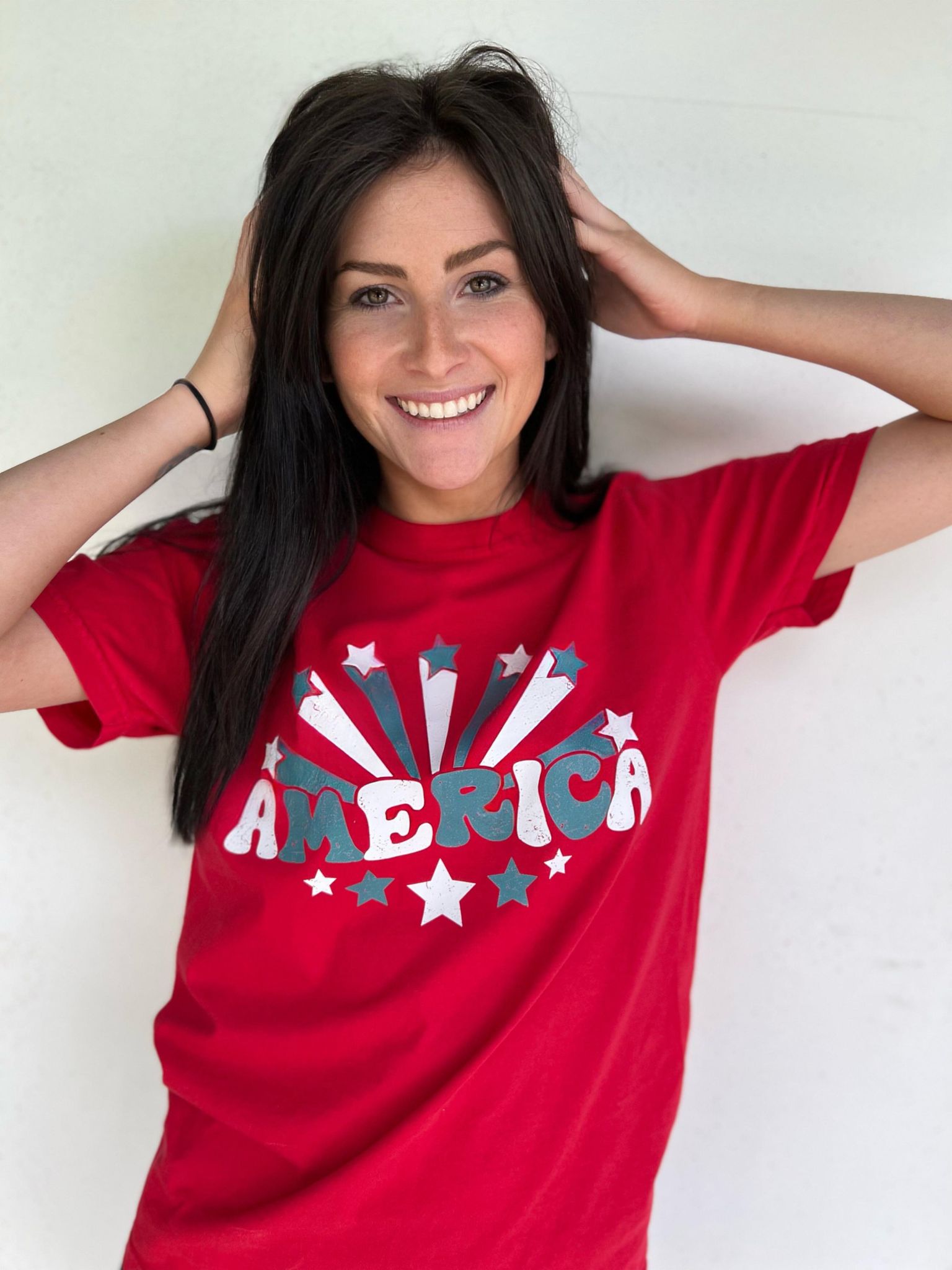 A vibrant red America Stars Tee featuring a patriotic design, perfect for 4th of July celebrations.