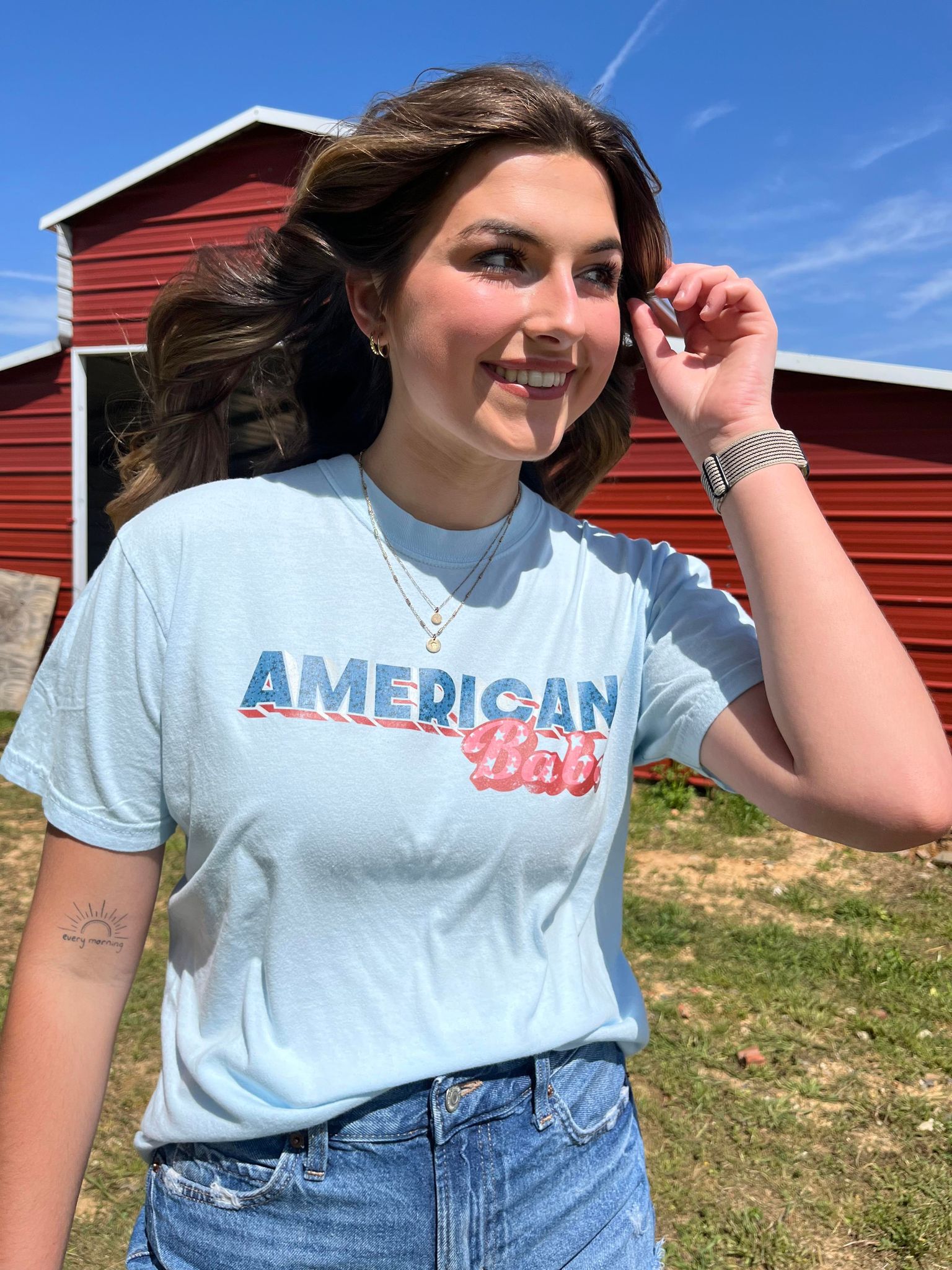 A soft, 100% cotton American Babe Tee in Chambray color, featuring a vibrant DTF printed design, perfect for 4th of July celebrations.