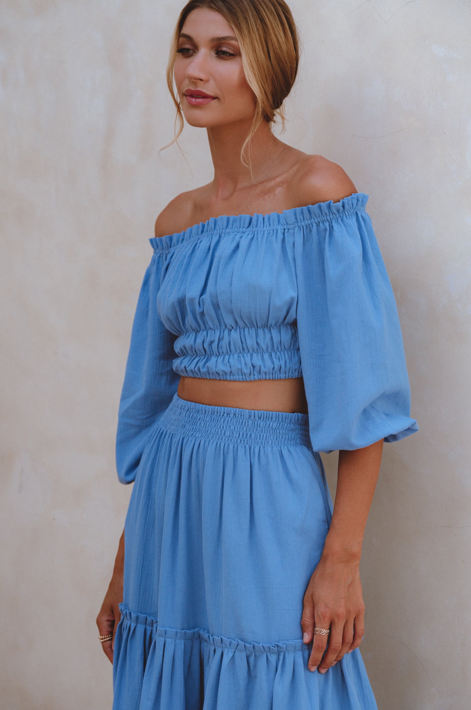 Annabelle Linen Cropped Top in crinkle linen with elasticated waist and sleeves, styled with a maxi skirt.