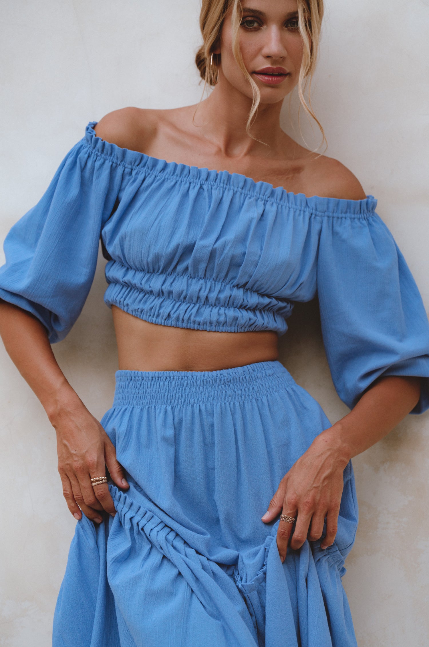 Annabelle Linen Cropped Top in crinkle linen with elasticated waist and sleeves, styled with a maxi skirt.