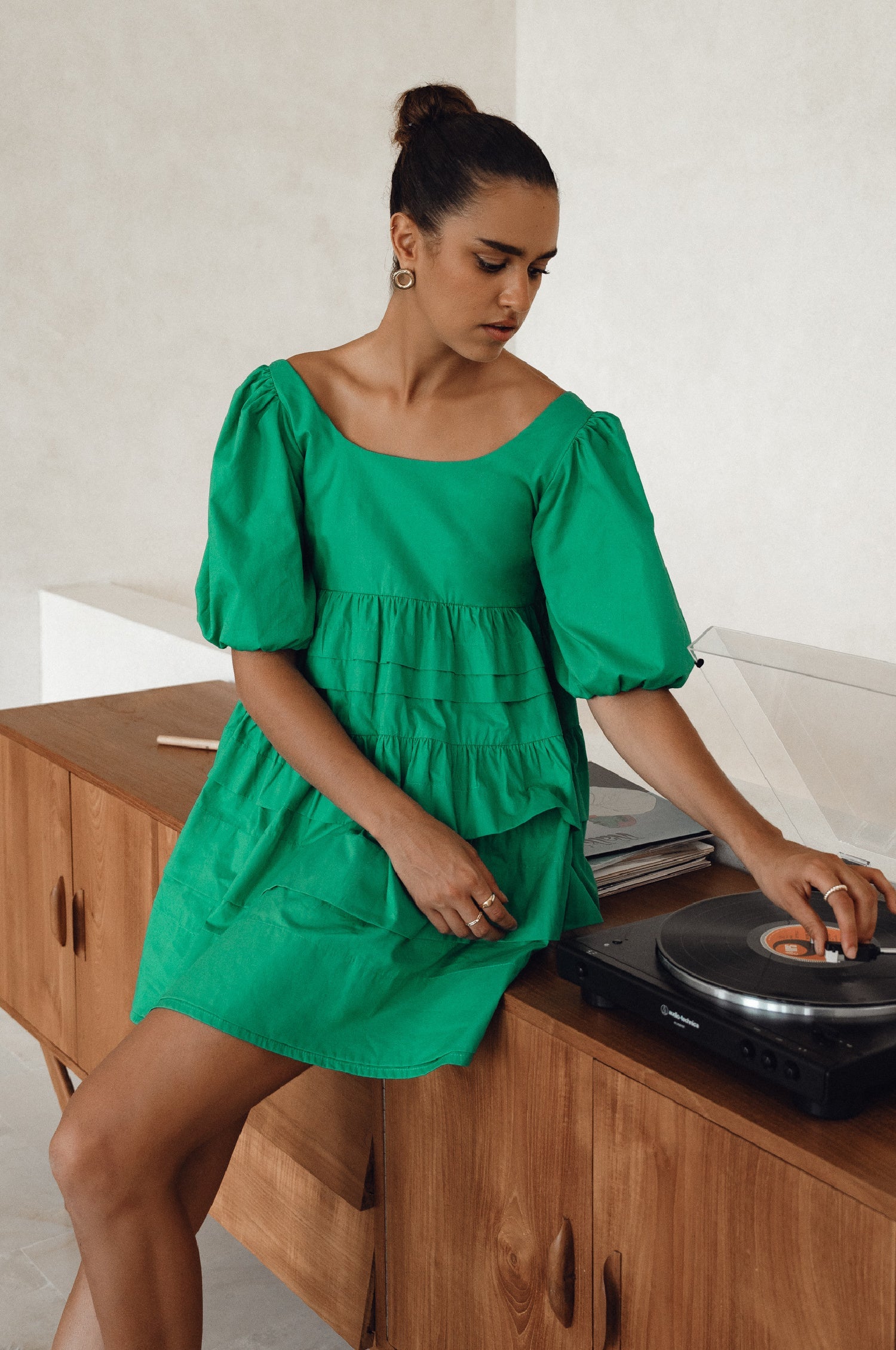 A stylish Andrea Babydoll Cotton Mini Dress featuring elasticated short sleeves, a round neckline, and a flowing hem, perfect for casual or evening wear.