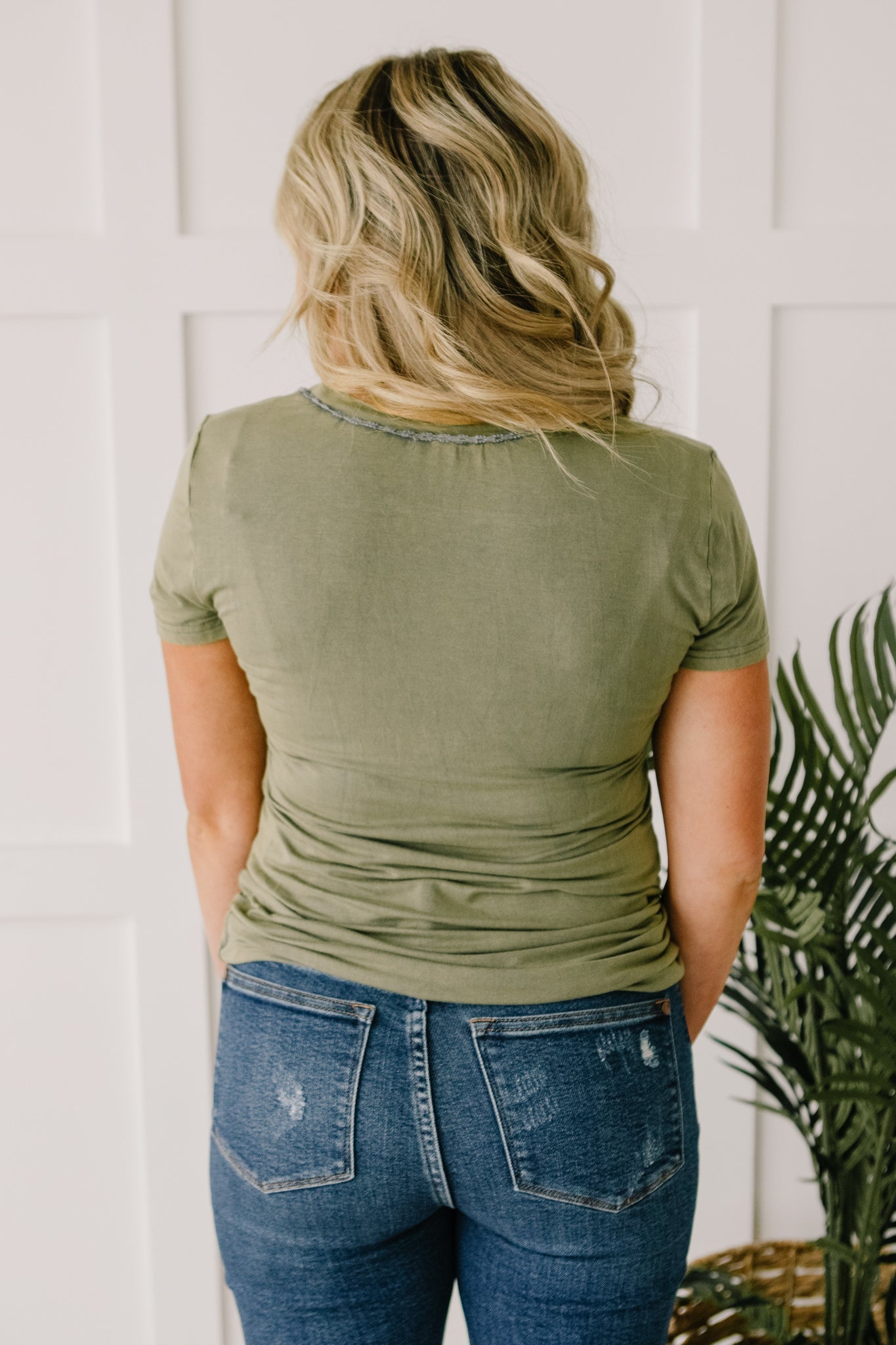 Andy Top in Olive featuring short sleeves and lace neckline detail, perfect for casual or dressy occasions.