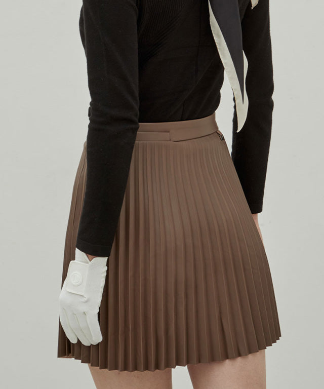 Anell Golf Bold Pleated Skirt in Brown, showcasing luxurious suede-combined leather with abundant pleats and a stylish design.