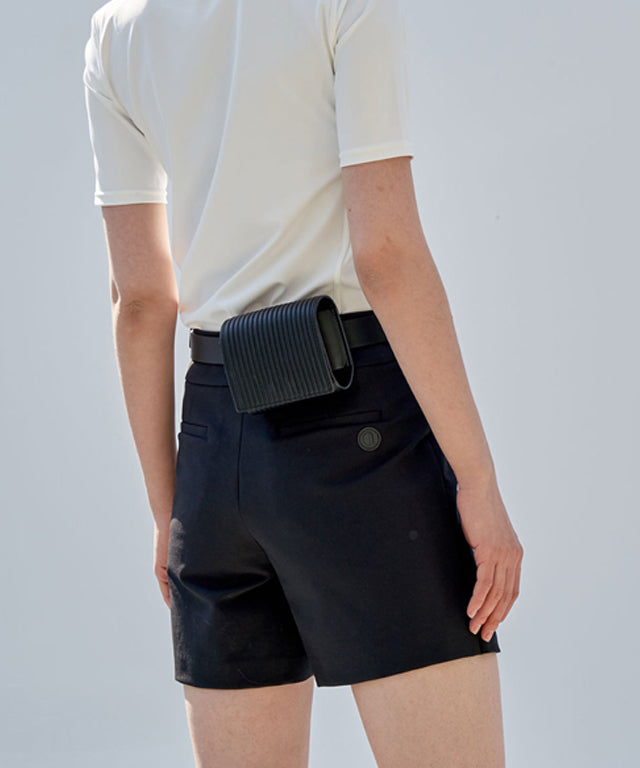 Anell Golf Classic H Skirt Pants in Black, showcasing a stylish skirt-pant hybrid design with front slit and belt loops.