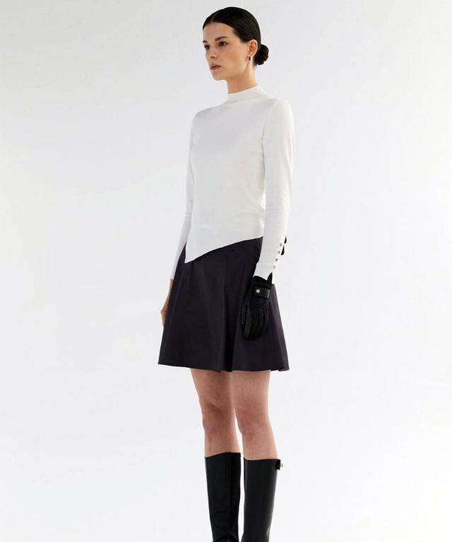 Anell Golf Classic Slim Knit Top in Ivory featuring a turtleneck and diagonal design details.