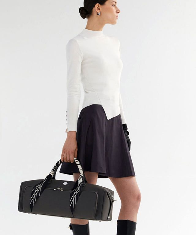 Anell Golf Classic Slim Knit Top in Ivory featuring a turtleneck and diagonal design details.