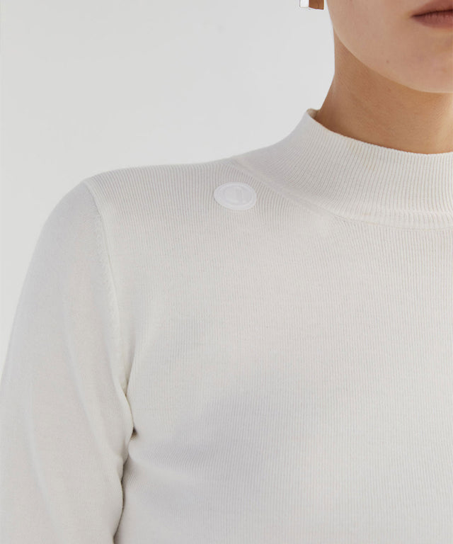 Anell Golf Classic Slim Knit Top in Ivory featuring a turtleneck and diagonal design details.