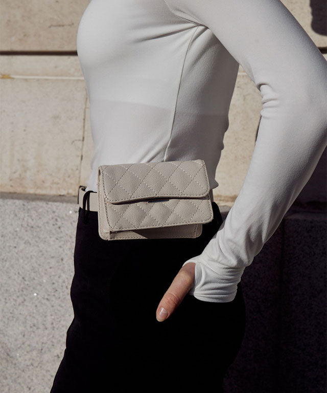 Anell Golf Quilted Belt Bag in black, white, and beige, showcasing stylish quilted design and adjustable belt.