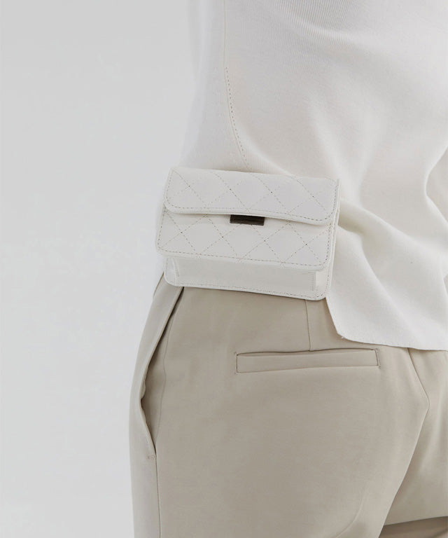 Anell Golf Quilted Belt Bag in black, white, and beige, showcasing stylish quilted design and adjustable belt.