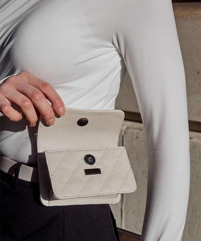 Anell Golf Quilted Belt Bag in black, white, and beige, showcasing stylish quilted design and adjustable belt.