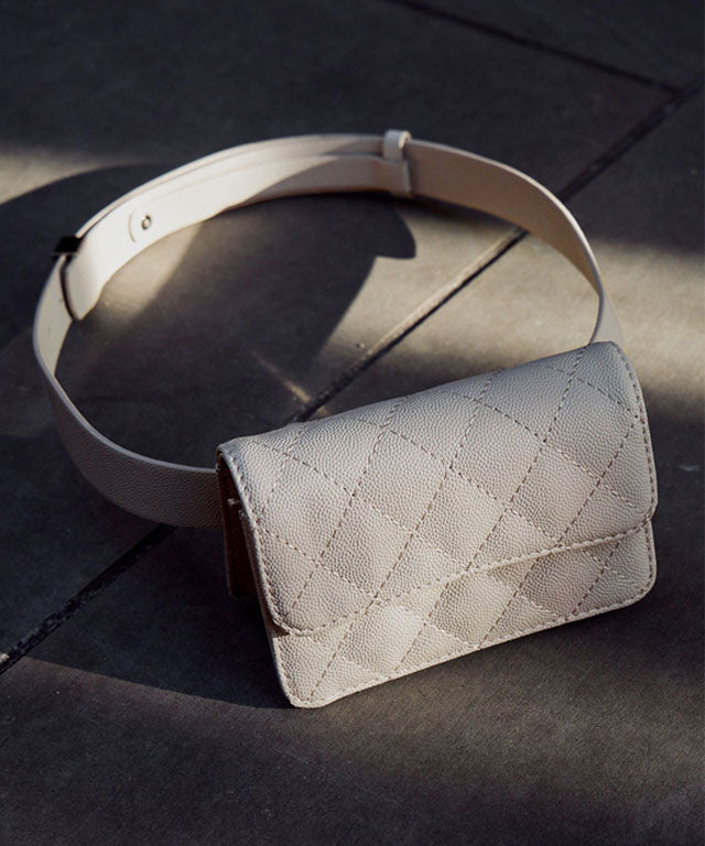 Anell Golf Quilted Belt Bag in black, white, and beige, showcasing stylish quilted design and adjustable belt.