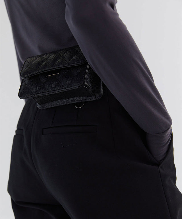 Anell Golf Quilted Belt Bag in black, white, and beige, showcasing stylish quilted design and adjustable belt.