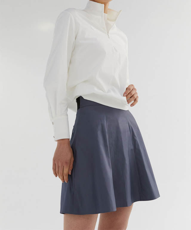 Anell Golf Slim Fit Full Skirt in Matte Blue, showcasing its voluminous flare and stylish design.