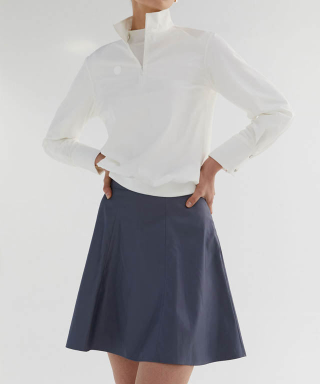 Anell Golf Slim Fit Full Skirt in Matte Blue, showcasing its voluminous flare and stylish design.