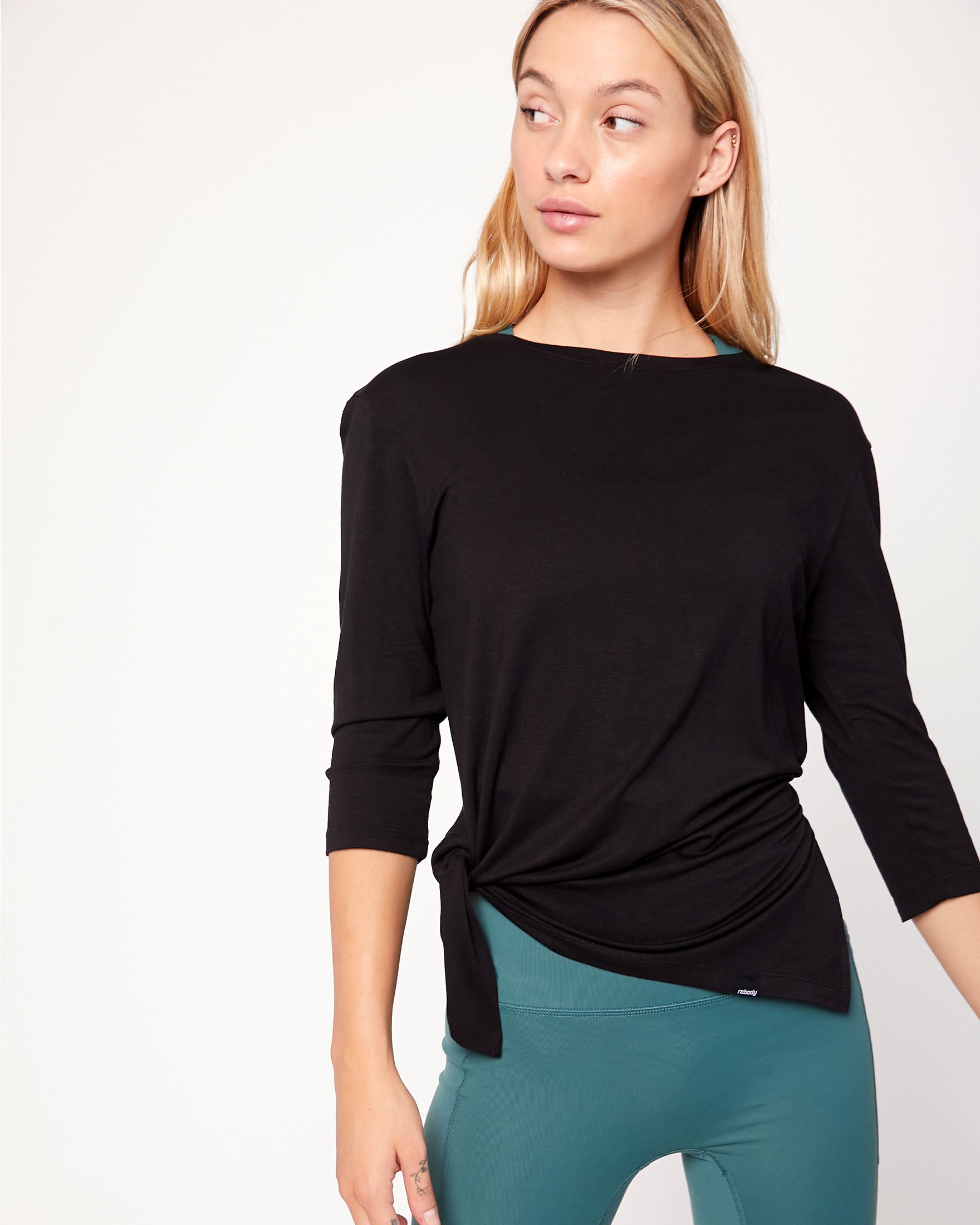 Anen Side Tie 3/4 Sleeve Top featuring a slightly elongated hem and customizable side tie design, made from cool rayon blend fabric.