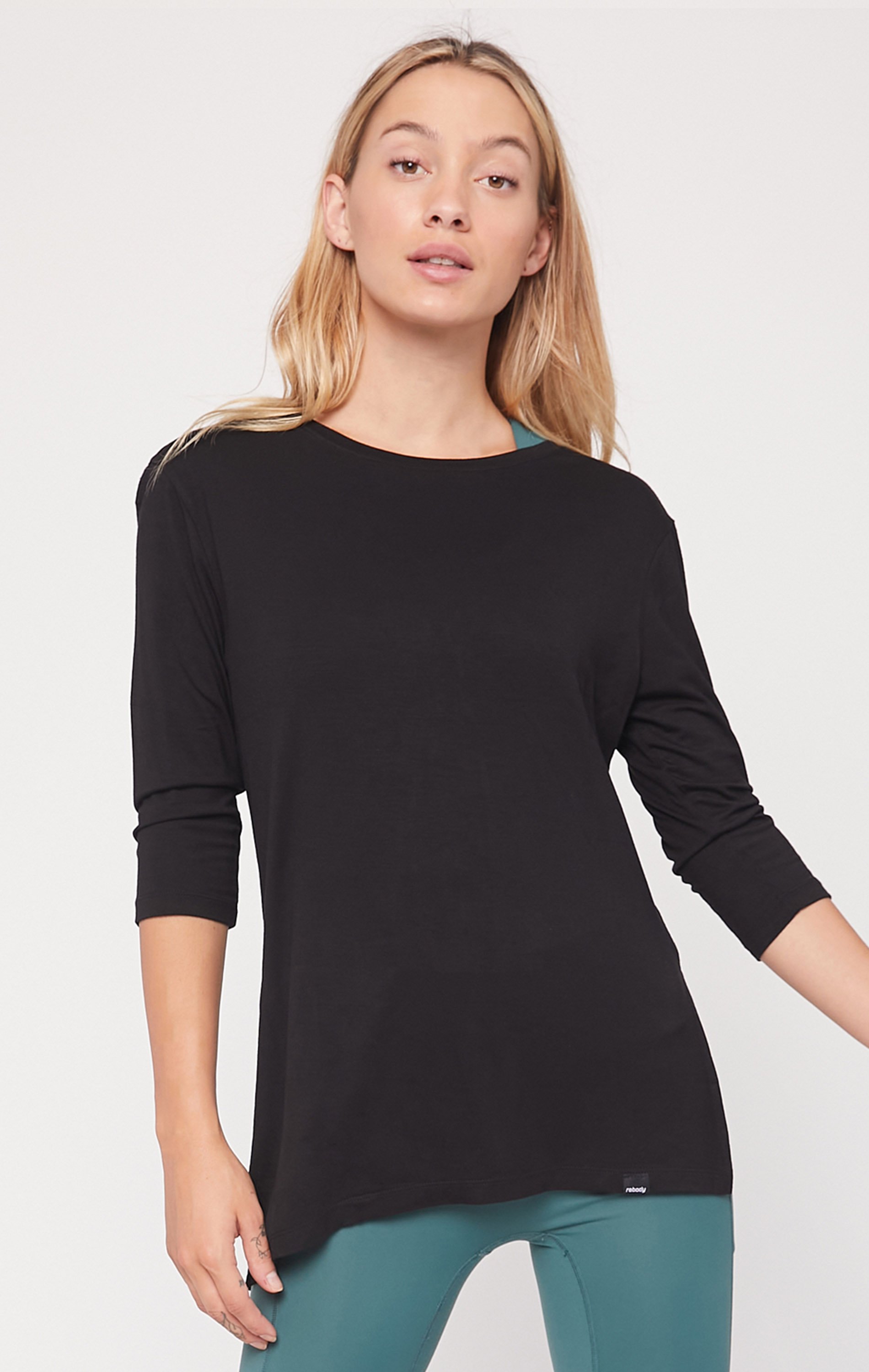 Anen Side Tie 3/4 Sleeve Top featuring a slightly elongated hem and customizable side tie design, made from cool rayon blend fabric.