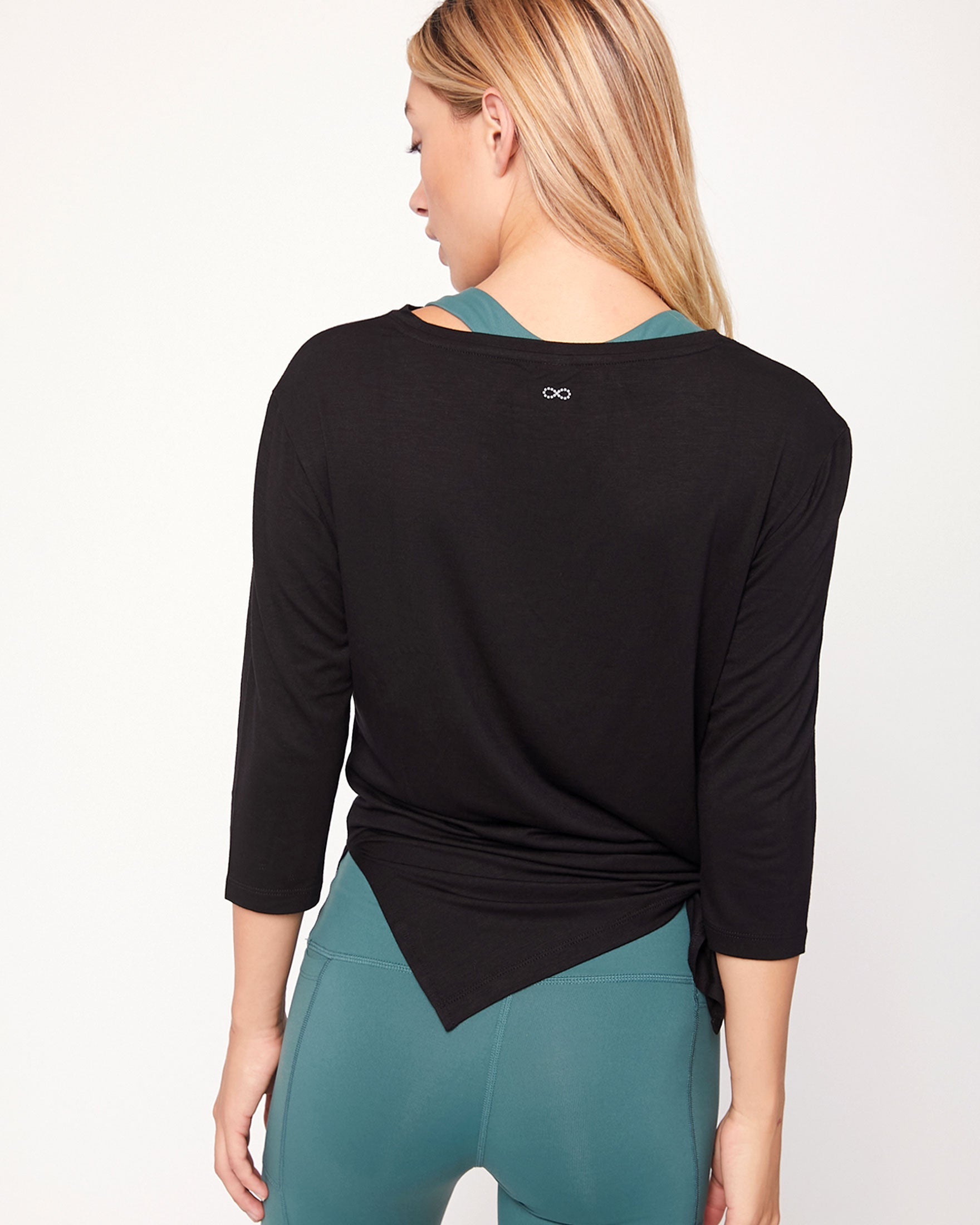 Anen Side Tie 3/4 Sleeve Top featuring a stylish side tie and elongated hem, perfect for layering and comfort.