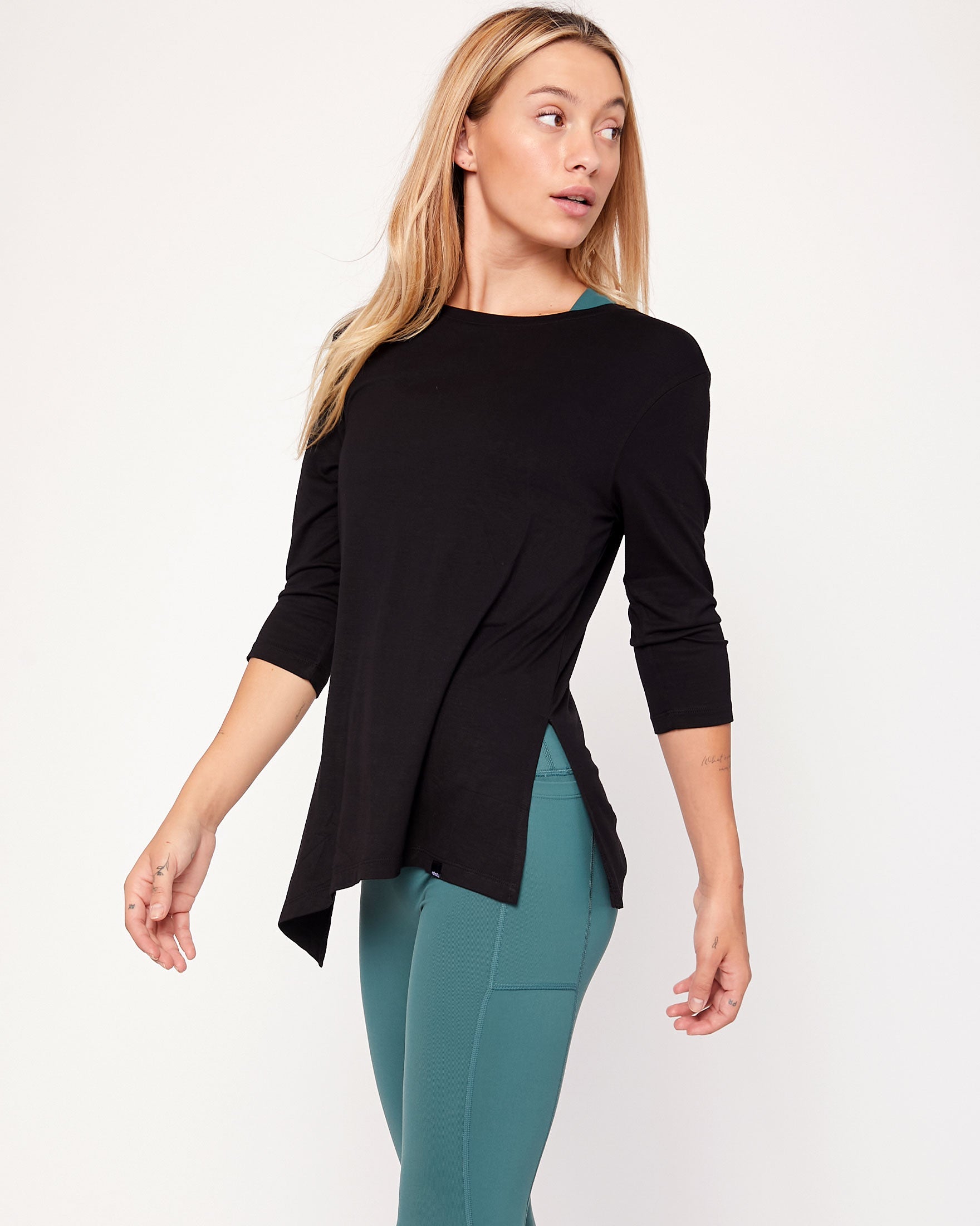 Anen Side Tie 3/4 Sleeve Top featuring a stylish side tie and elongated hem, perfect for layering and comfort.