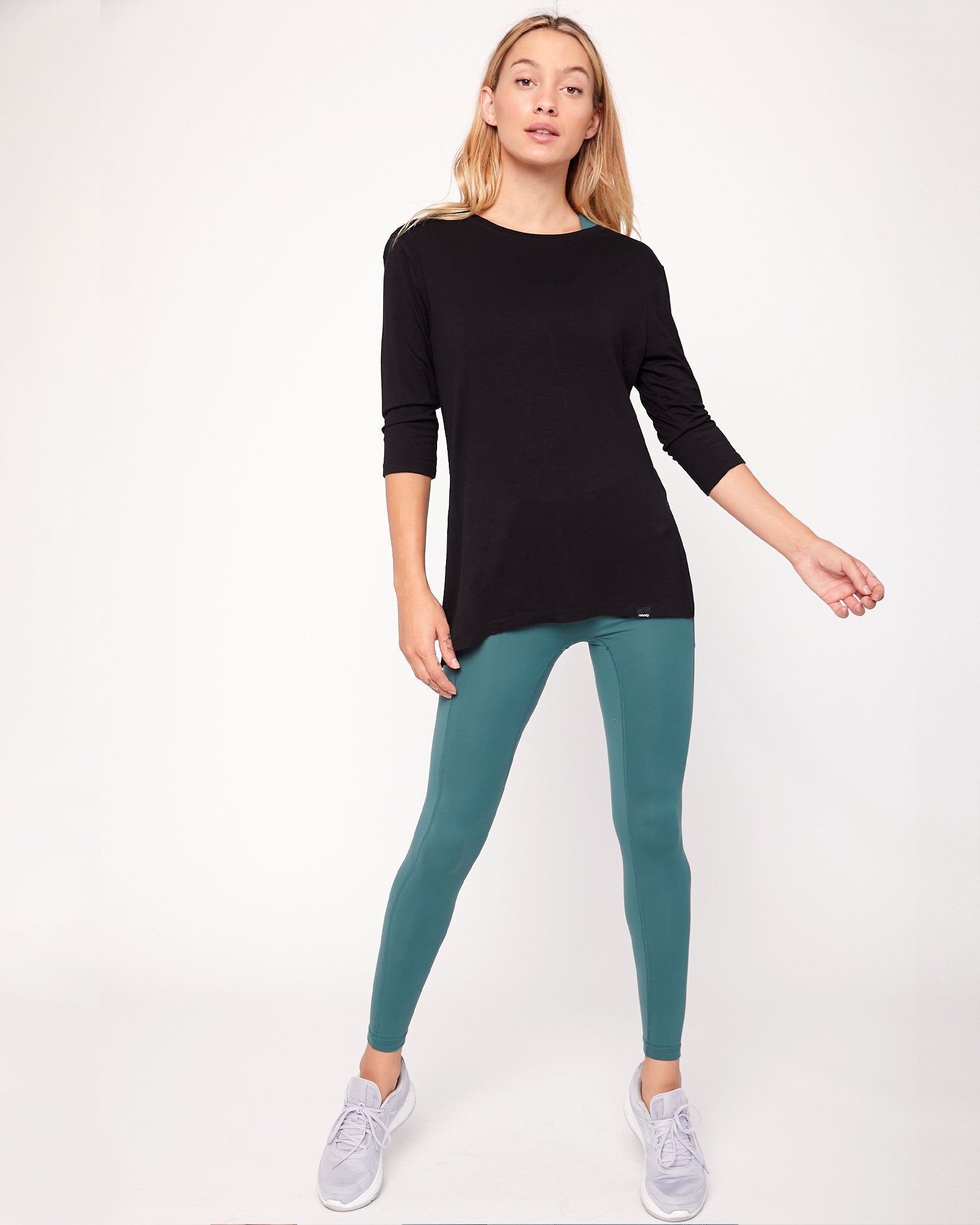 Anen Side Tie 3/4 Sleeve Top featuring a stylish side tie and elongated hem, perfect for layering and comfort.