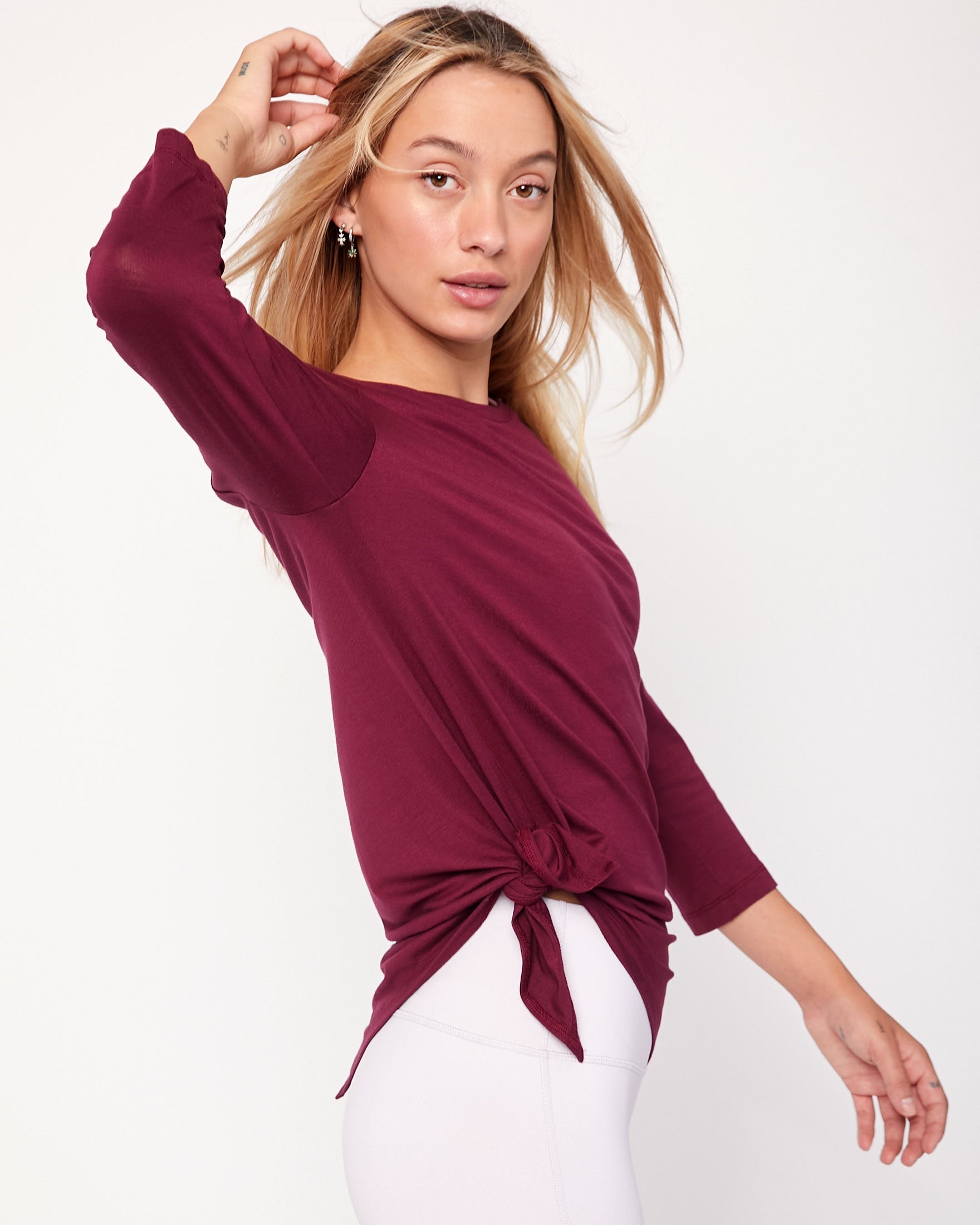 Anen Side Tie 3/4 Sleeve Top featuring a stylish side tie and elongated hem, perfect for layering and comfort.