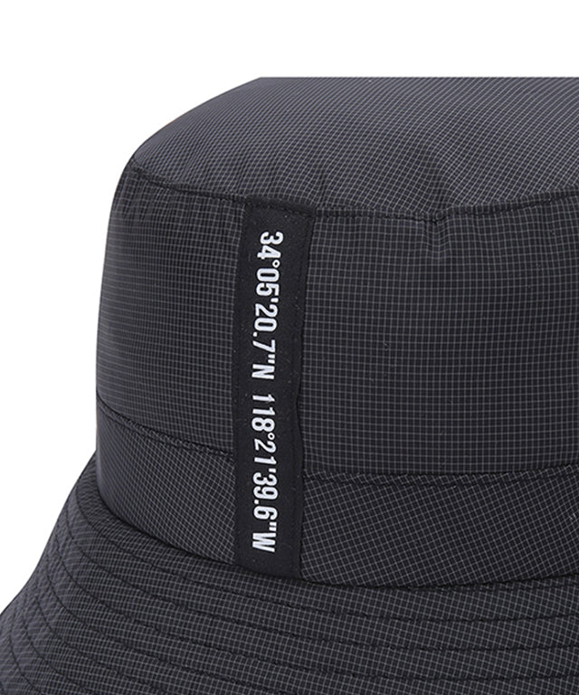 ANEW Golf Nylon Ripstop Bucket Hat featuring a stylish graphic logo, lightweight design, and detachable strap for windy conditions.