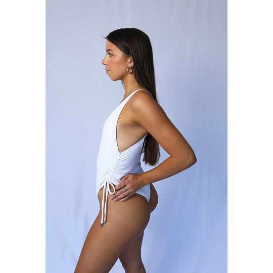 Angelina One Piece in White featuring adjustable side straps for a customizable fit, designed to accentuate curves.