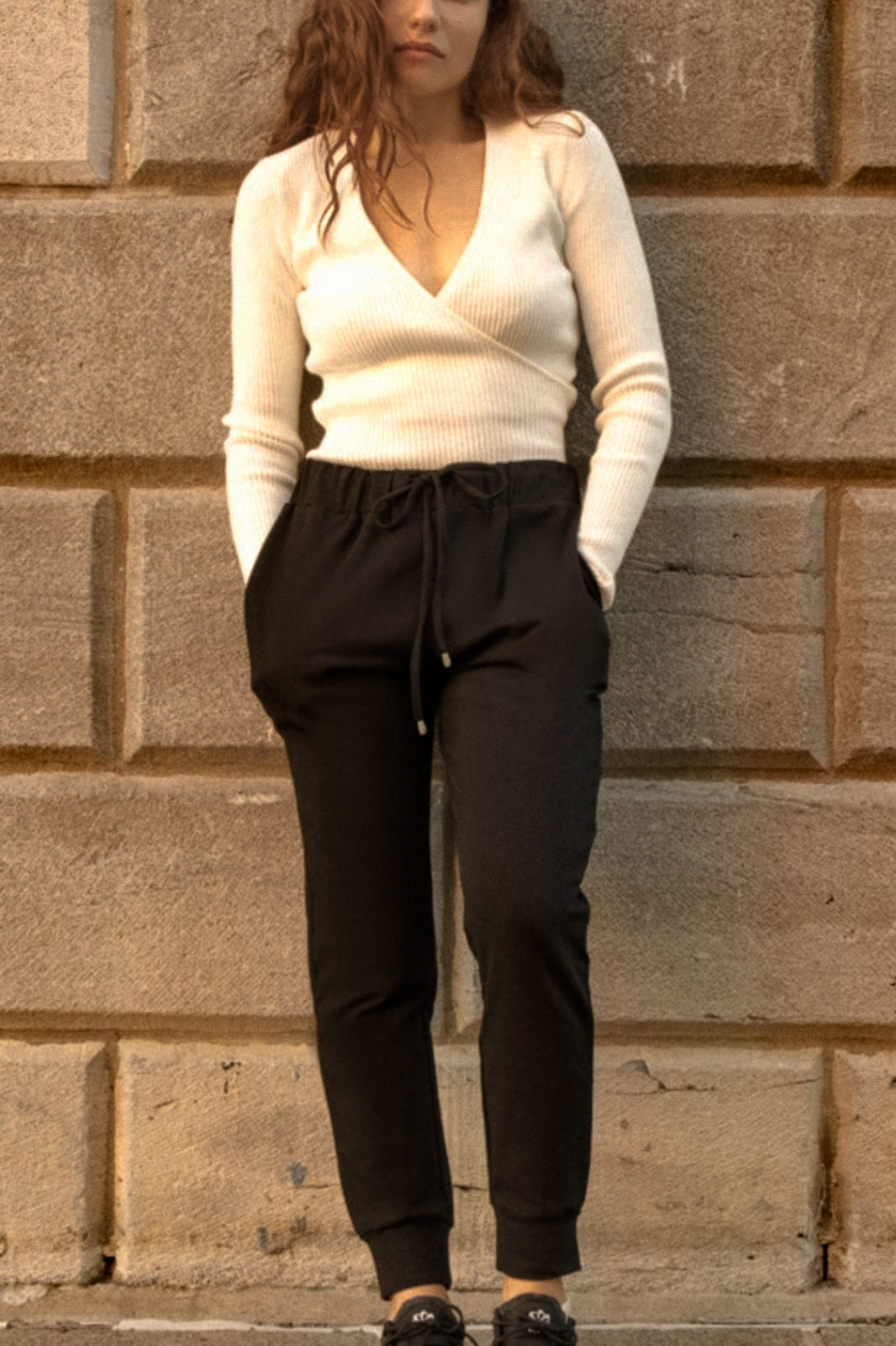 Angie Chic Quality Sweatpants in black with drawstring waist and side pockets, showcasing a relaxed fit and ribbed cuffs.