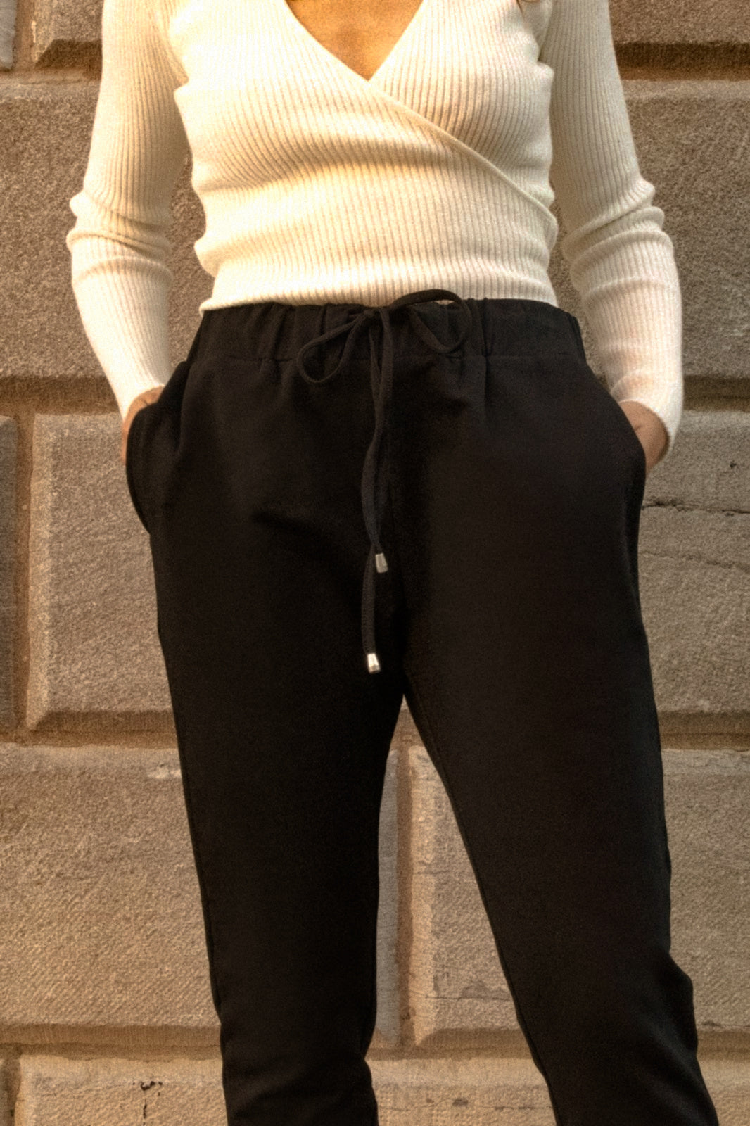 Angie Chic Quality Sweatpants in black with drawstring waist and side pockets, showcasing a relaxed fit and ribbed cuffs.