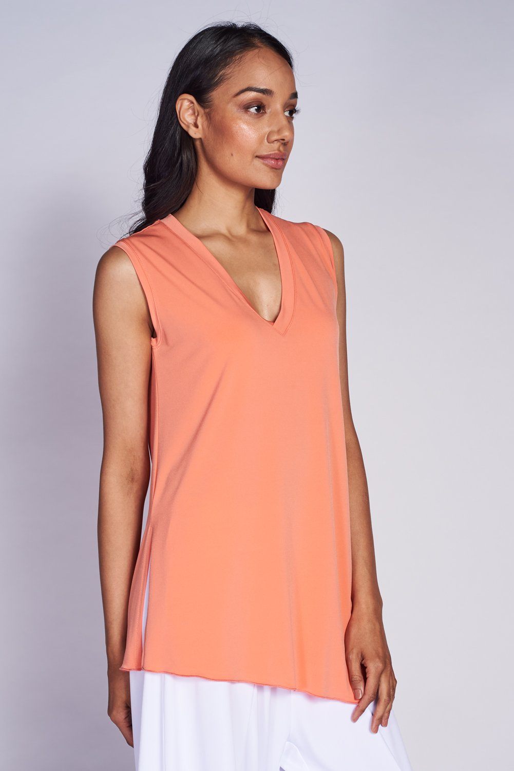 A stylish Angled Tank Top featuring wider shoulder straps and a side slit, made from soft lightweight fabric.