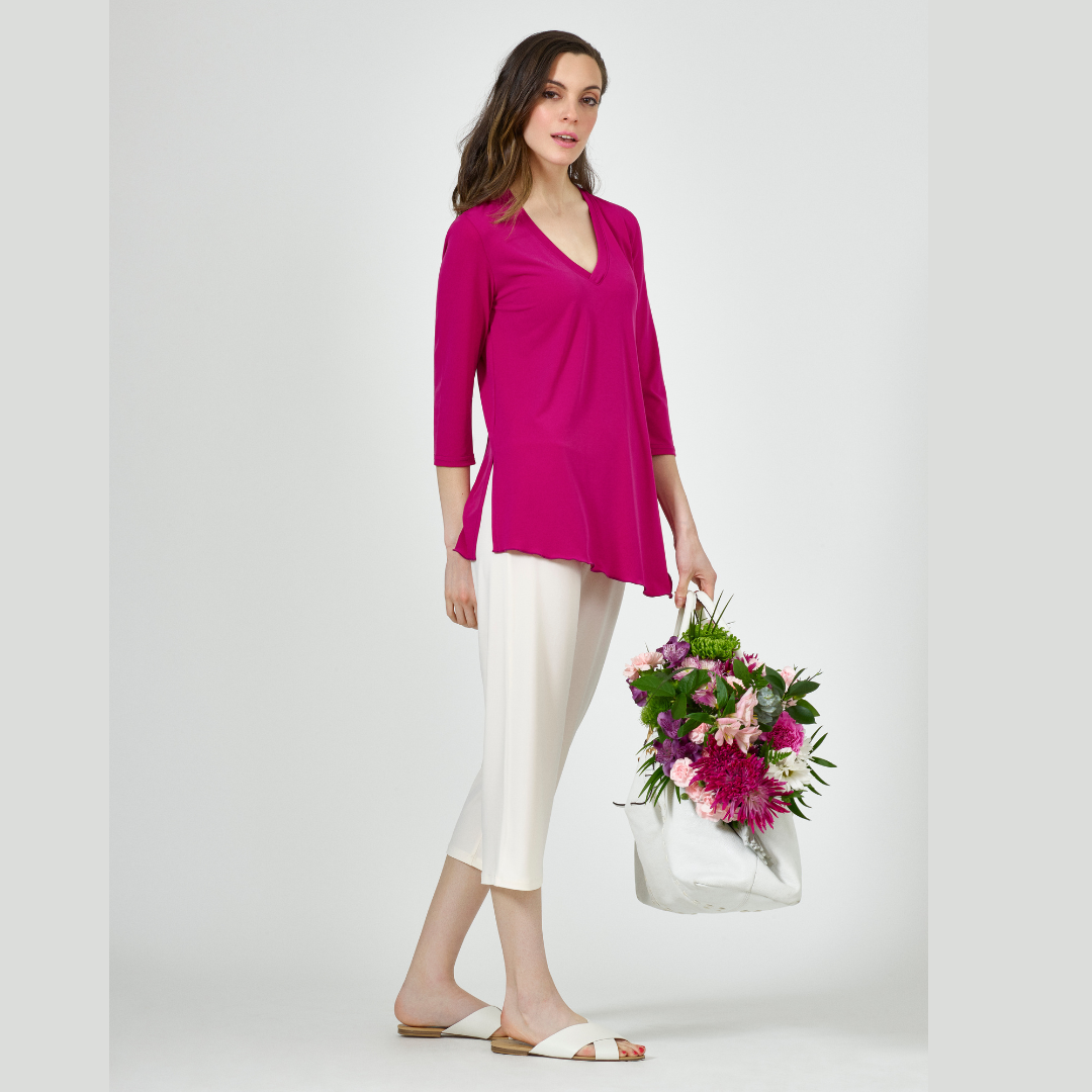 A stylish Angled Top featuring a V-neck, 3/4 sleeves, and an elegant angled hem with side slits for comfort.