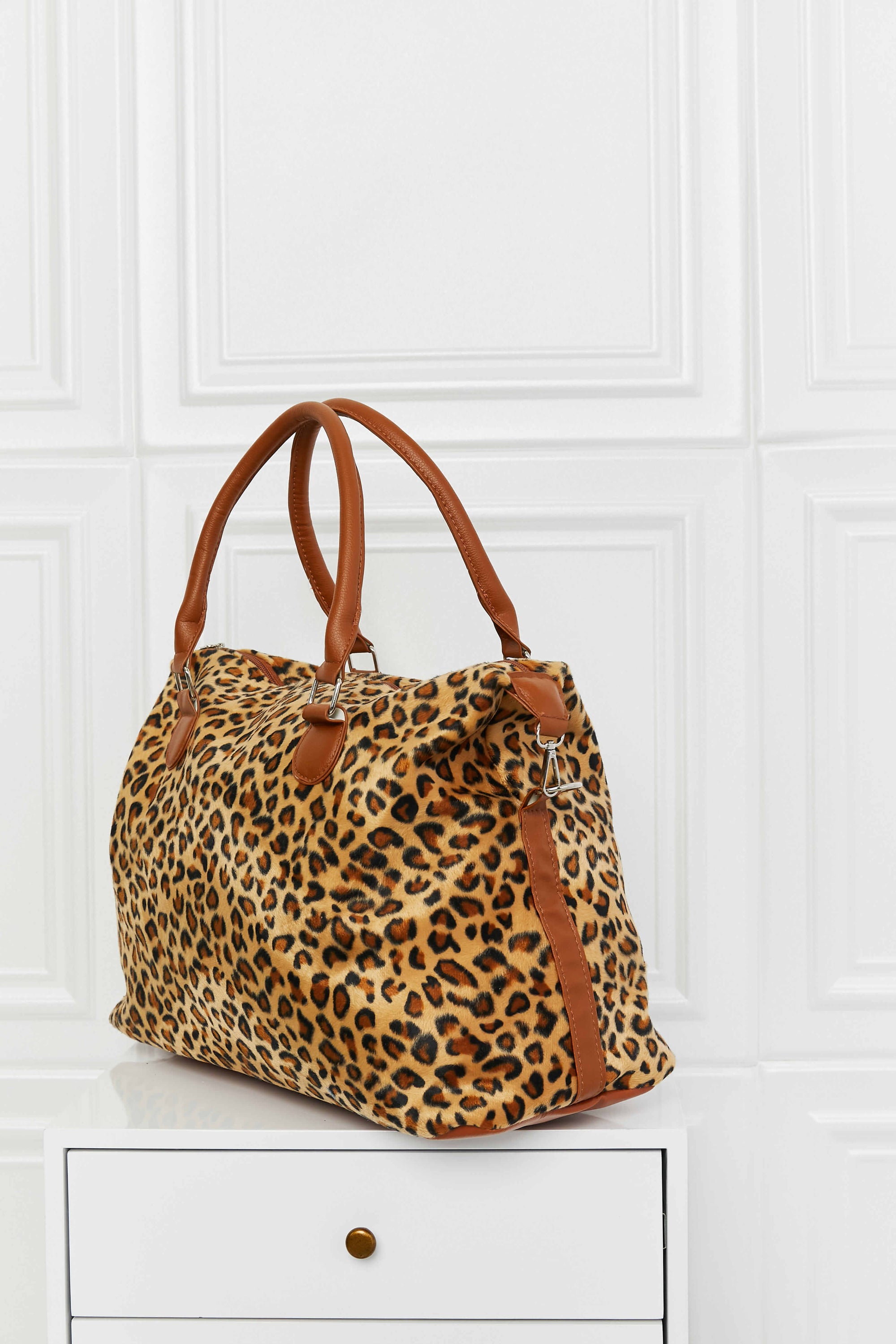 Animal Print Brushed Weekender Bag featuring a leopard pattern, medium size, and top handle for easy carrying.