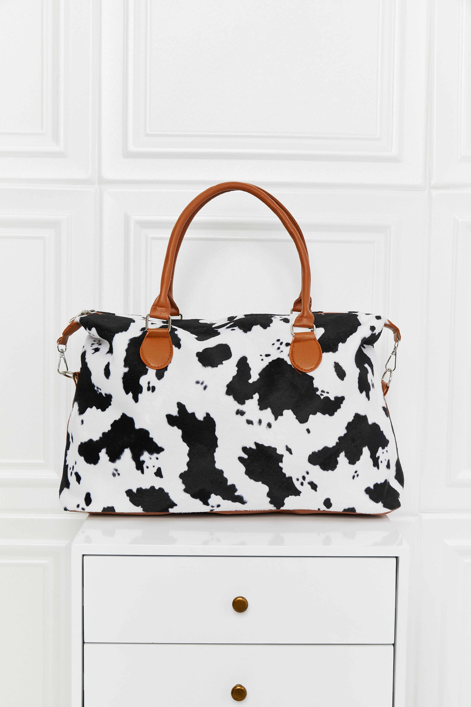 Animal Print Brushed Weekender Bag featuring a leopard pattern, medium size, and top handle for easy carrying.