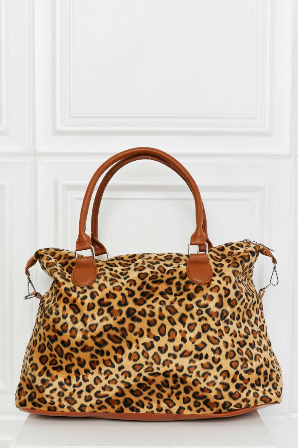 Animal Print Brushed Weekender Bag featuring a leopard pattern, medium size, and top handle for easy carrying.