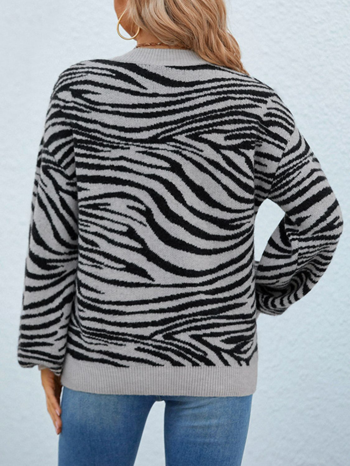 Animal Print Dropped Shoulder Sweater in various colors, showcasing its trendy design and relaxed fit.