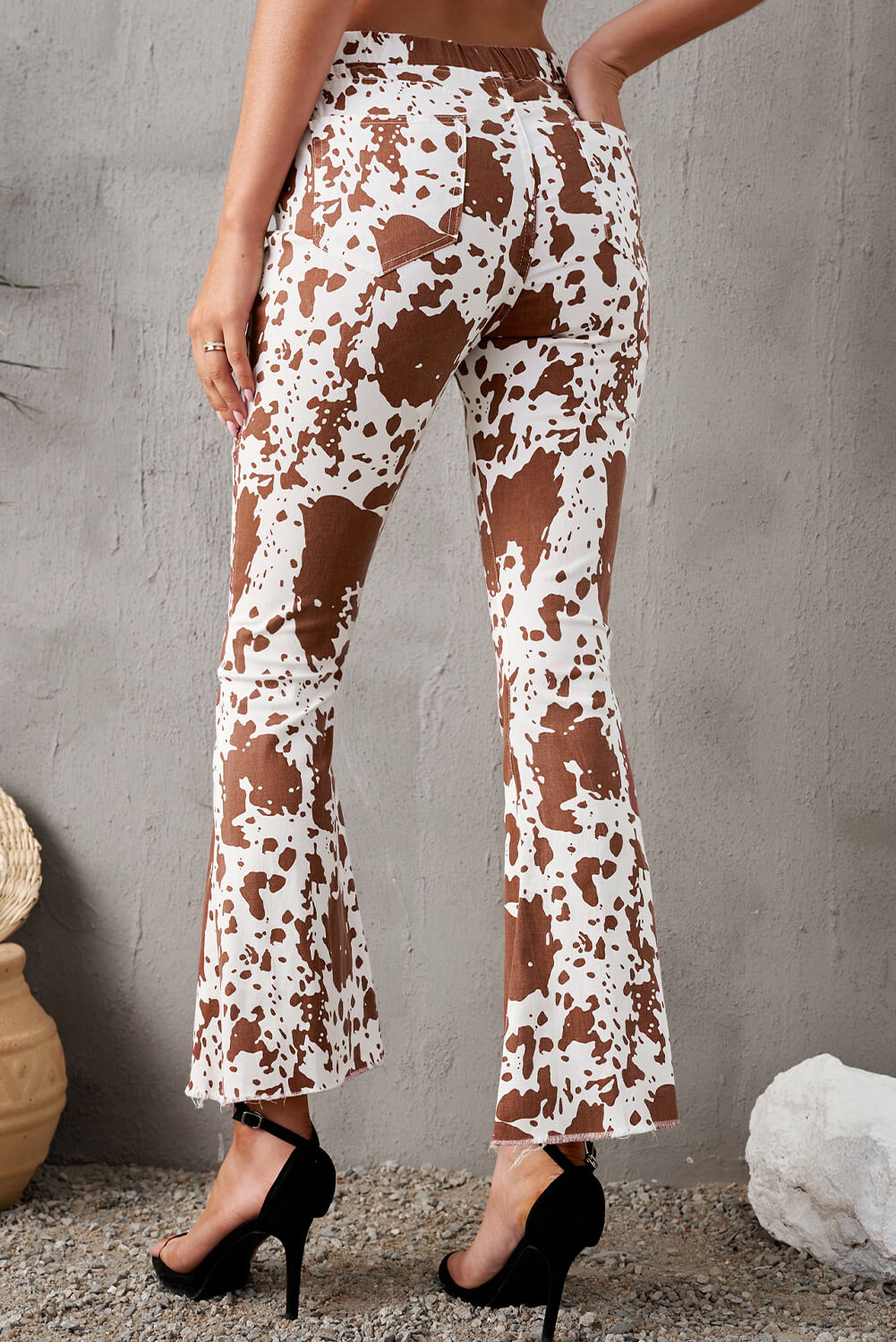 A pair of stylish animal print flare pants with pockets, featuring a trendy design and a comfortable fit, perfect for casual wear.