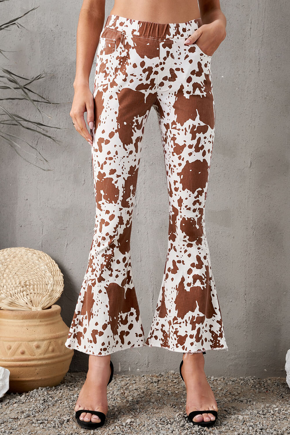 A pair of stylish animal print flare pants with pockets, featuring a trendy design and a comfortable fit, perfect for casual wear.