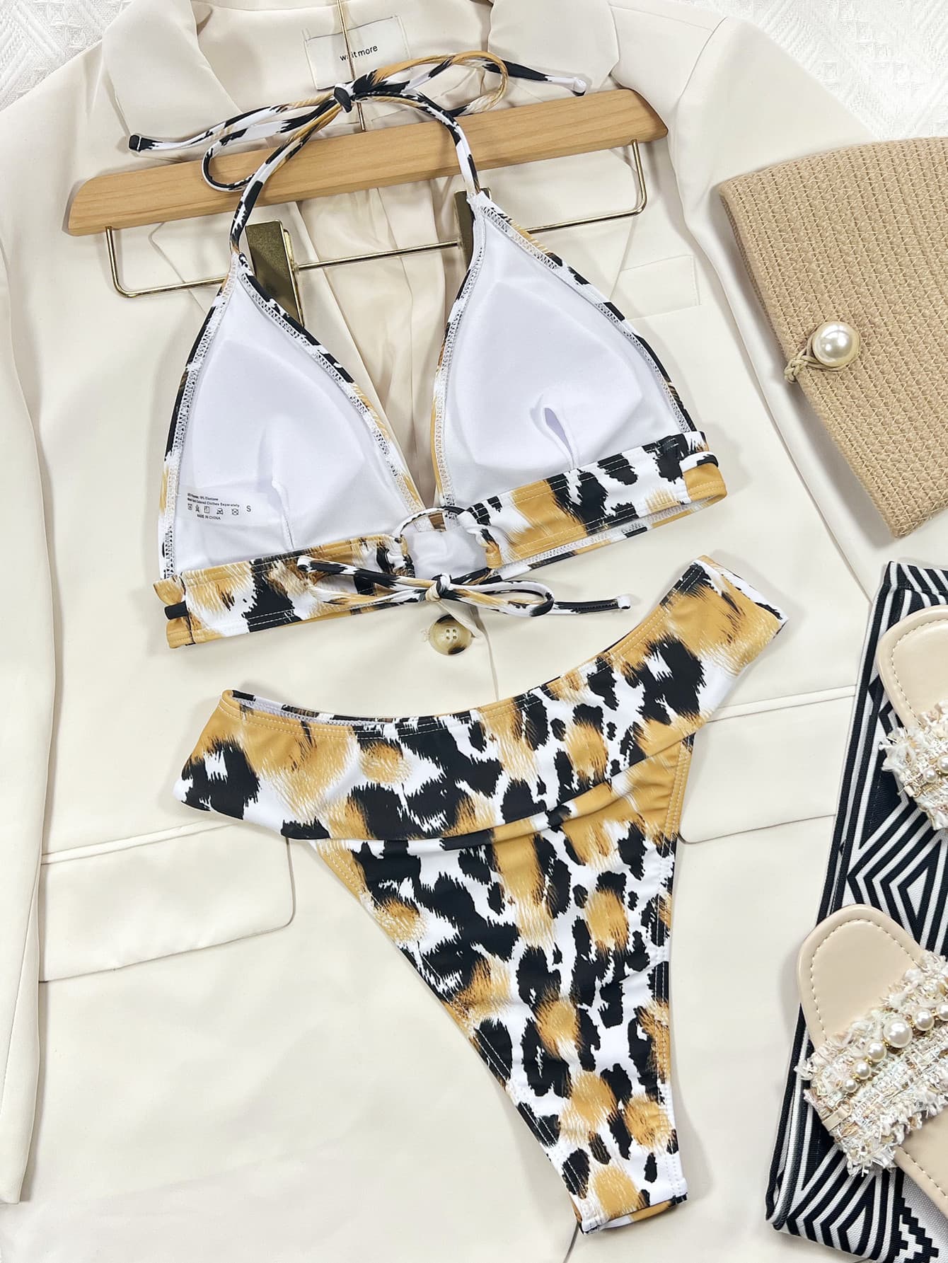 Animal Print Halter Neck Bikini Set featuring a stylish design with removable padding and mid-waist bottoms, perfect for beach outings.