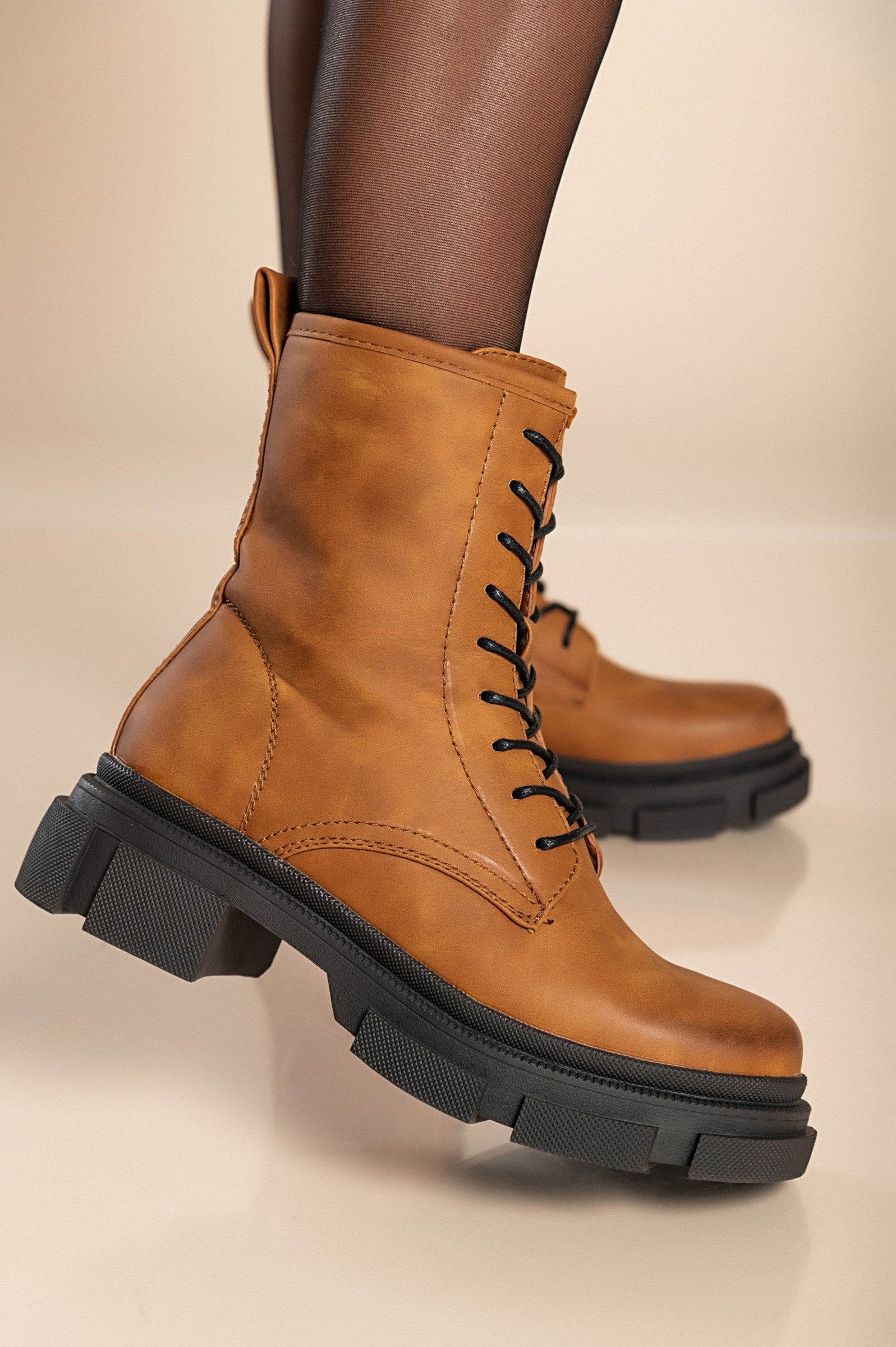 Stylish camel ankle boots with laces and side zipper, featuring a round toe and raised sole.