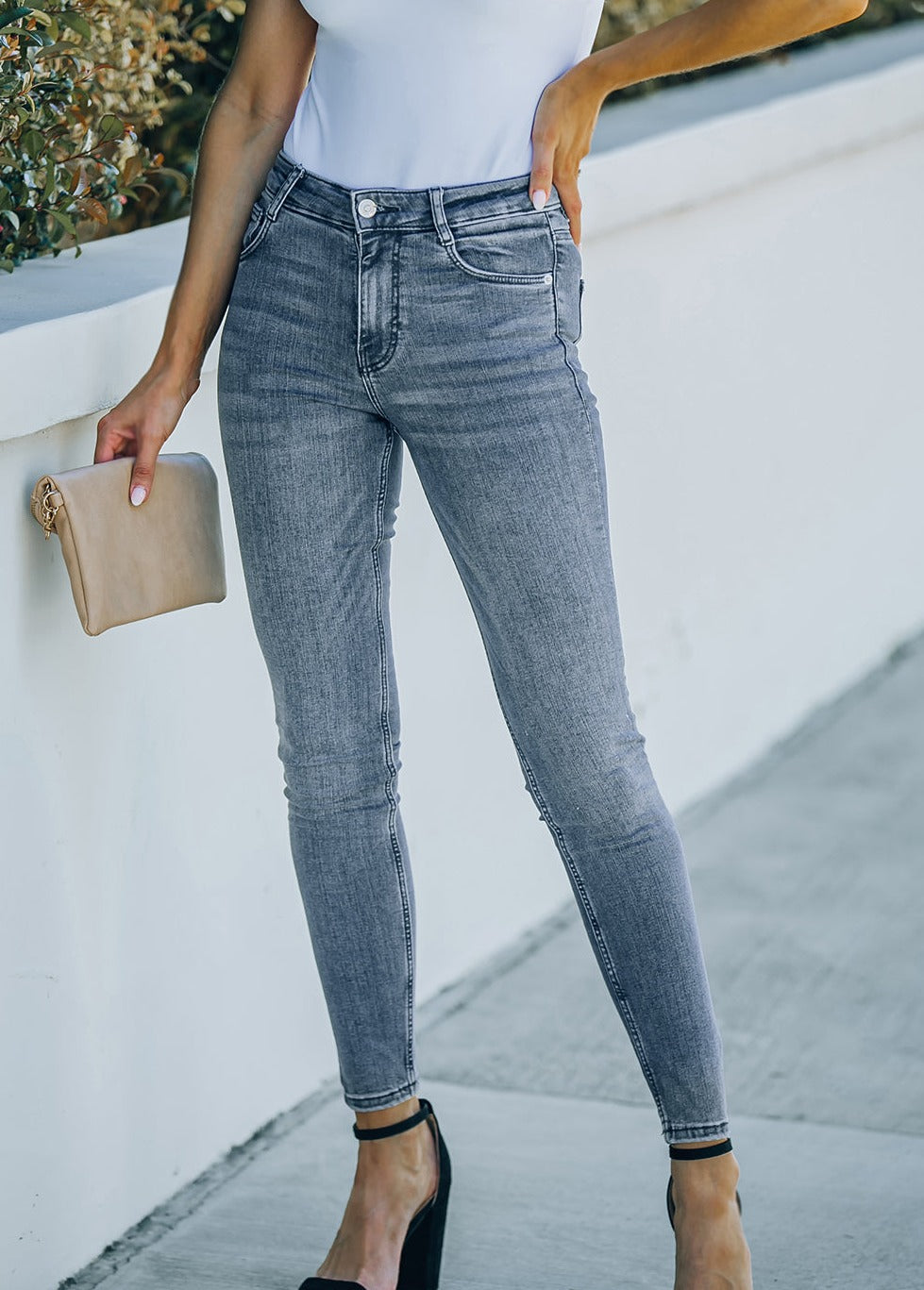 A pair of stylish ankle-length skinny jeans with pockets, showcasing a solid pattern and a slightly stretchy fabric for comfort.