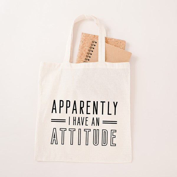 A stylish canvas tote bag featuring the phrase 'Apparently I have an Attitude' in bold lettering, perfect for everyday use.