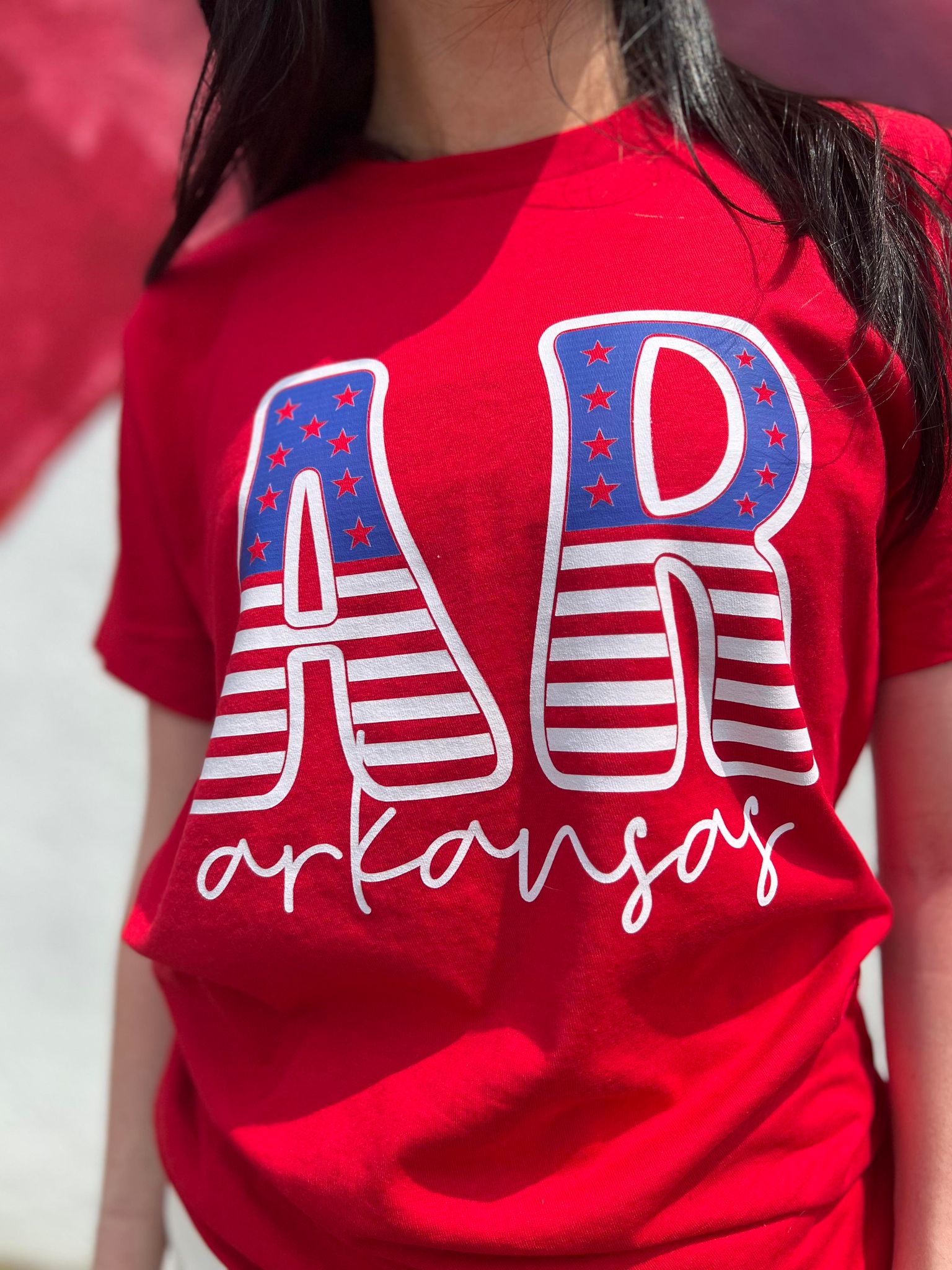 A stylish Arkansas Stars and Stripes Tee featuring vibrant colors and a comfortable fit, perfect for celebrating the 4th of July.