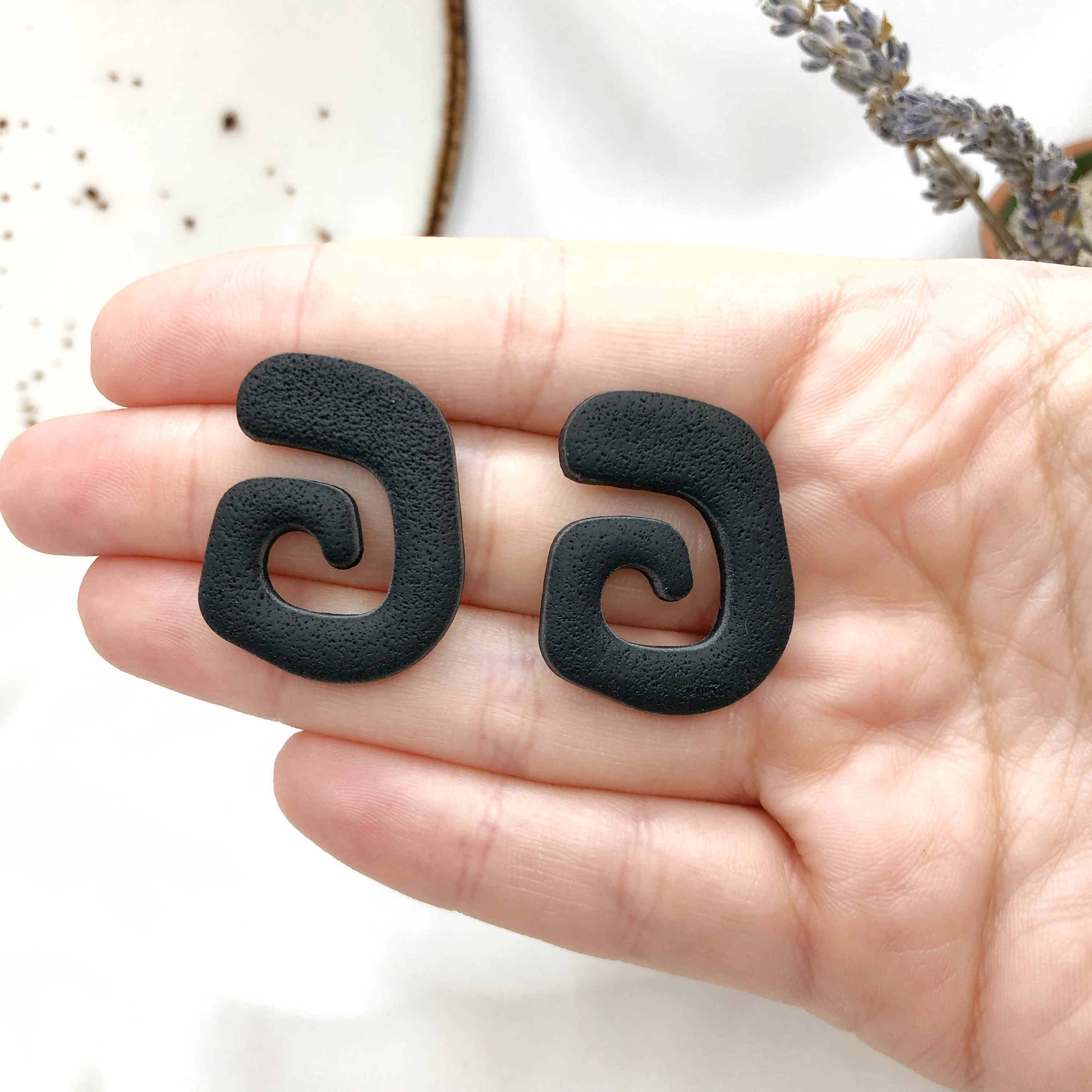 Artisan made black polymer clay earrings, lightweight and nickel-free, showcasing unique handmade design.