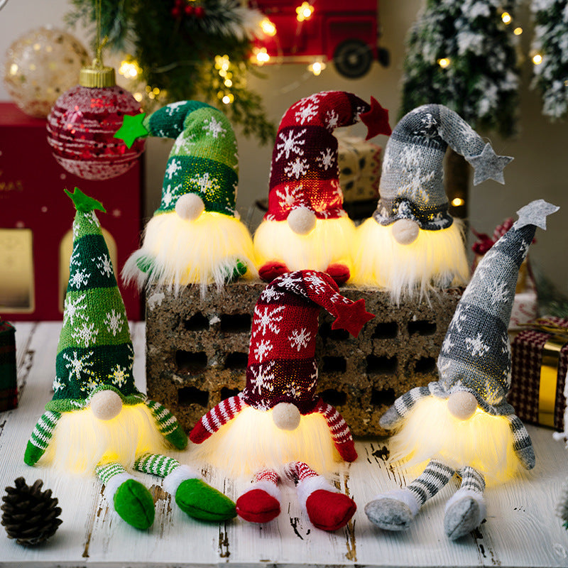 Two assorted light-up faceless gnomes in vibrant colors, showcasing their whimsical design and glowing features.