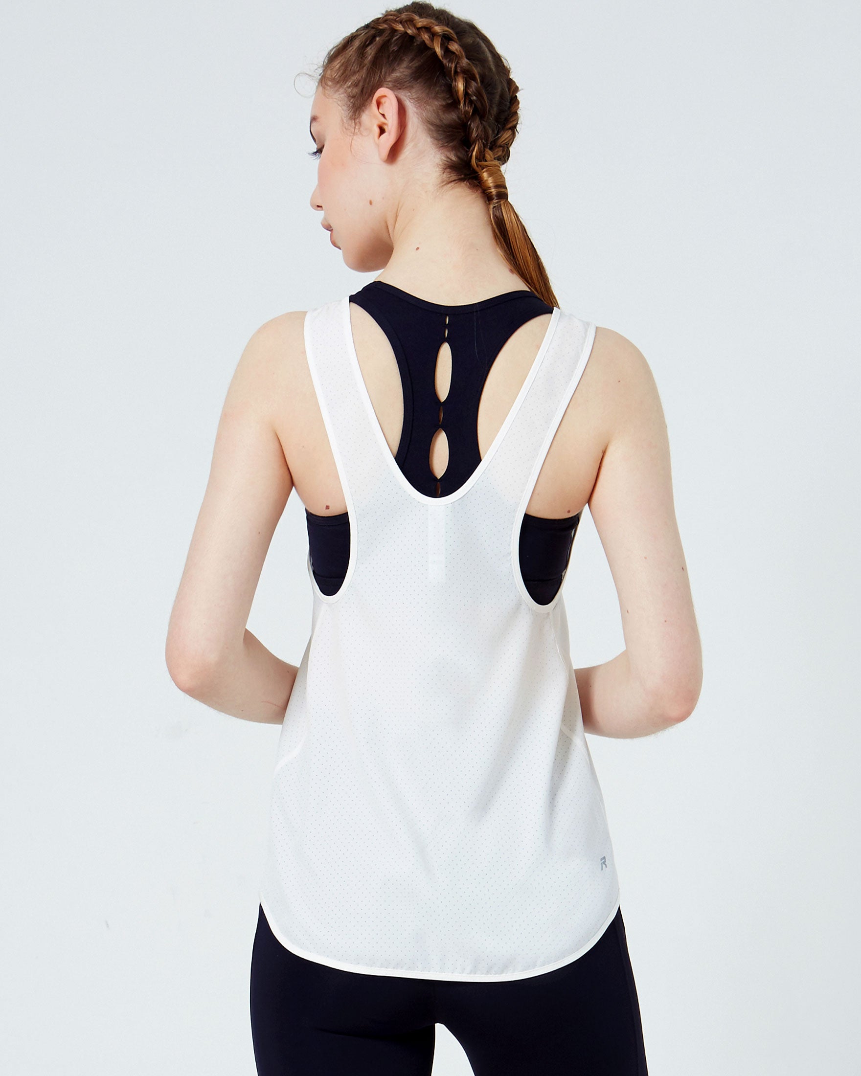 Atlas Laser Cut Mesh Tank featuring a low scooped racerback design and breathable laser cut mesh fabric, ideal for workouts and water activities.