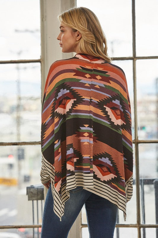 Azi Two Fer Poncho featuring a modern Aztec print, lightweight fabric, and stylish high neck design.