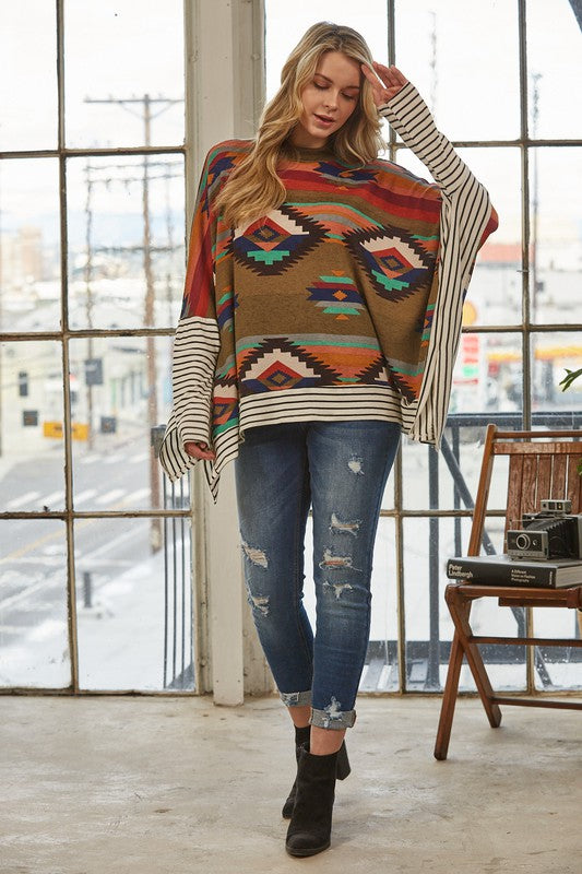 Azi Two Fer Poncho featuring a modern Aztec print, lightweight fabric, and stylish high neck design.