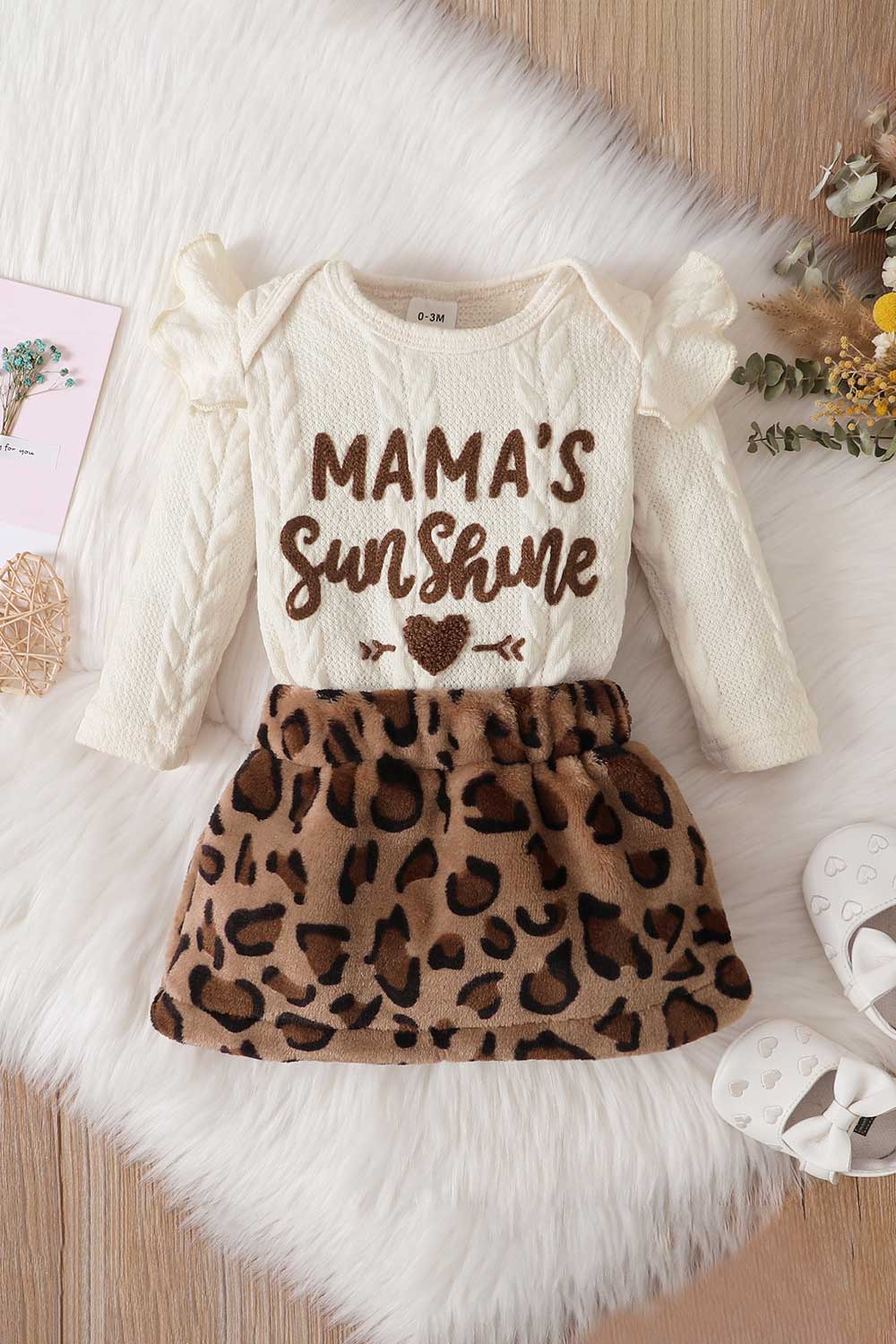 Baby girl wearing a letter graphic sweater and leopard print skirt, showcasing a stylish and comfortable outfit for infants.