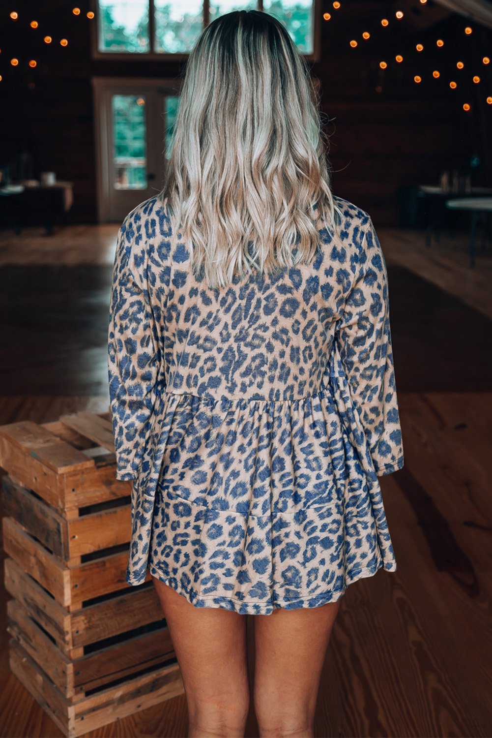 A stylish Babydoll Button Leopard Print Top featuring a chic leopard pattern and 3/4 sleeves, perfect for any season.