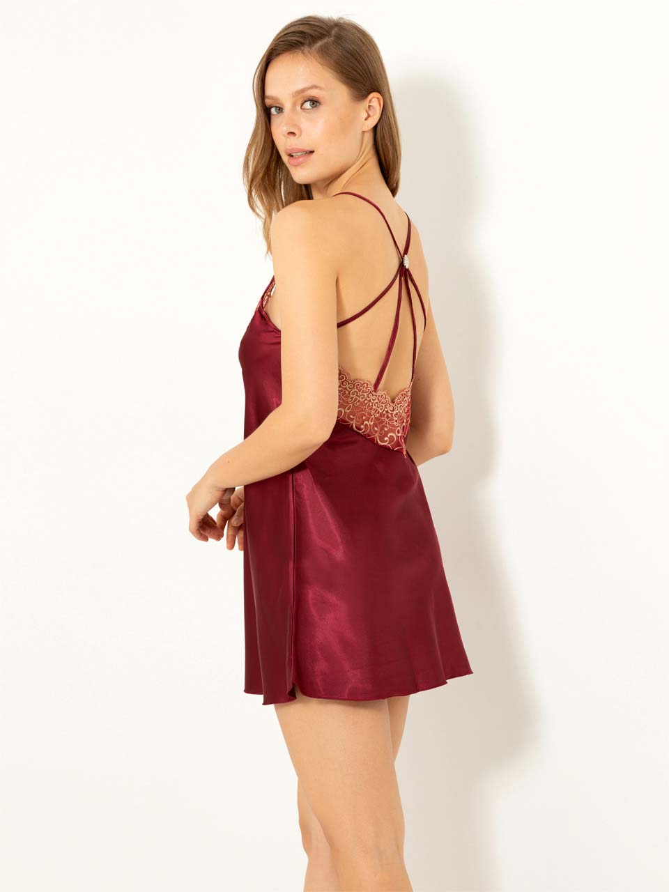 Elegant backless mini sleepwear with cross straps and Guipure embroidery, showcasing luxurious satin fabric.